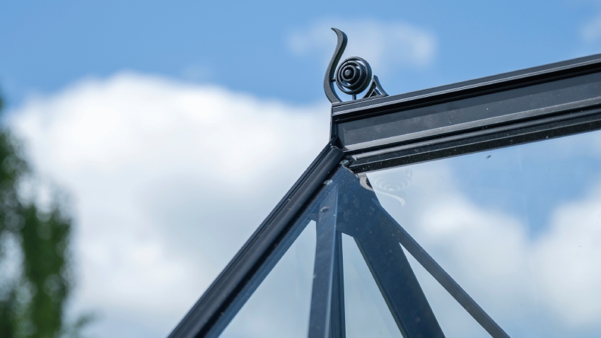 Close-up of roof cresting installed on the Halls ICON 8 8x14 Greenhouse, finished with horticultural glass and a powder-coated black aluminium frame.
