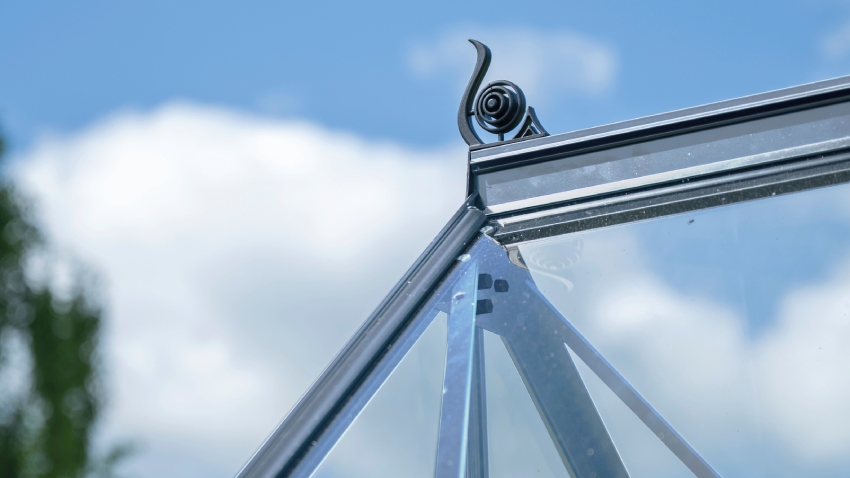 Close-up of the roof cresting on the Halls ICON 8 8x12 Greenhouse, finished with horticultural glass and a natural mill aluminium frame.