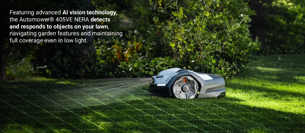 Husqvarna Automower® 405VE NERA robotic lawn mower operating on a grass lawn in a garden, shown navigating around plants using AI-assisted vision, with overlaid text describing its object detection and low-light navigation capabilities.