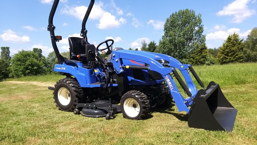 Iseki TXGS24 23hp sub-compact tractor with front loader attachment lifted outdoors