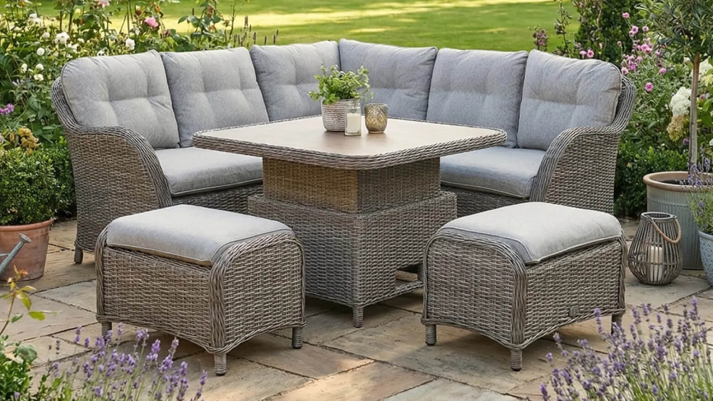 LeisureGrow St Tropez sand compact modular dining set with table arranged outdoors, featuring corner sofa seating, cushioned footstools and square rattan dining table in a garden setting
