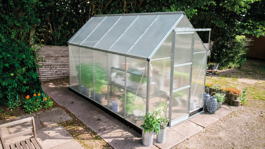 Wide-angled image of the Halls ICON 6 6x10 Greenhouse, with polycarbonate glazing and a natural mill aluminium frame.