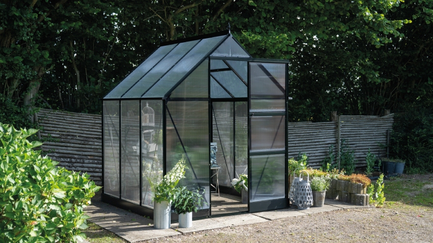 Wide-angled image of the Halls ICON 6 6x4 Greenhouse, with polycarbonate glazing and a powder-coated black aluminium frame.