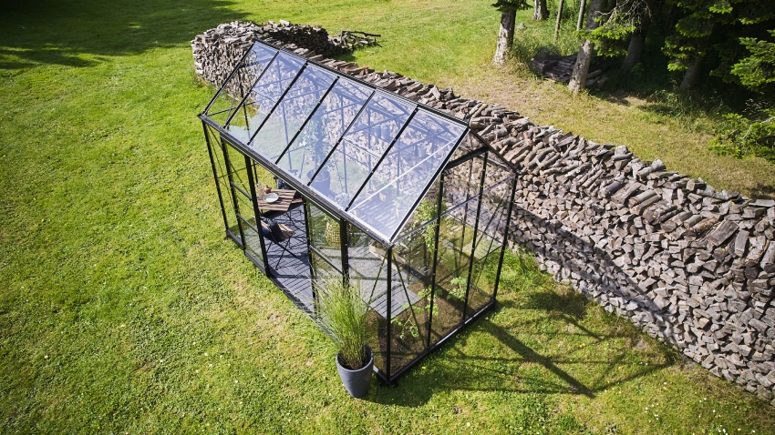 Wide-angled image of the Halls ICON Planthouse 6 6x12, with toughened glass and a powder-coated black aluminium frame.
