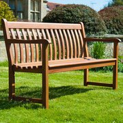 Alexander Rose Cornis Broadfield 4ft garden bench in mahogany hardwood with ergonomic curved backrest and armrests in outdoor setting
