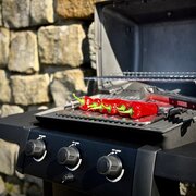 Close-up of red peppers grilling on the Broil King Gem 310 Shadow Gas BBQ