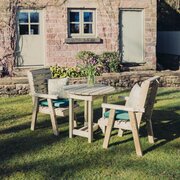 Churnet Valley Clover 2 Seater Wooden Bistro Table Set in a garden environment