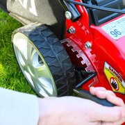 Close-up of cutting height adjustment lever on Cobra M40SPCVX self-propelled petrol lawnmower