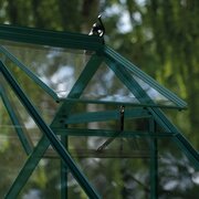 Close-up of the open roof vent on a green Halls Icon 6 6x6 greenhouse, showing the toughened glass and metal frame.