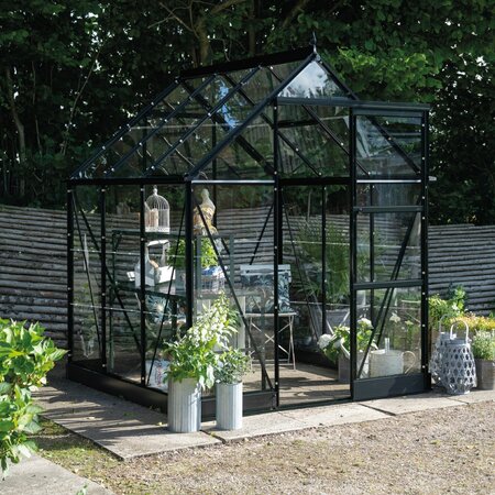 Halls Icon 6 6x6 greenhouse in black aluminium with toughened glass panels, shown fully assembled in a garden setting. Pre-order and save £287.