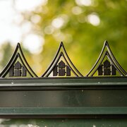 Close-up of the Halls ICON 6 greenhouse roof cresting HR01957, showing the black decorative ridge detail fitted to the top of a 6x8 greenhouse frame.