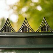 Close-up of the Halls ICON 8 greenhouse roof cresting HR01963, showing the black decorative ridge detail fitted to the top of an 8×14 greenhouse frame.