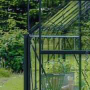 Halls Icon downpipe kit installed on a Halls ICON greenhouse, directing rainwater away from the frame.