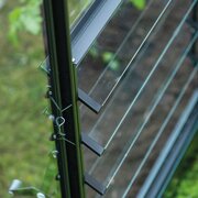 Close-up of the black Halls ICON greenhouse standard louvre kit showing toughened glass blades and powder-coated aluminium frame.
