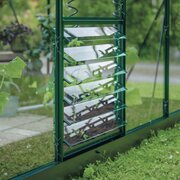 Halls ICON greenhouse standard louvre kit in green installed in the rear wall, providing plant-level ventilation inside a green ICON greenhouse.