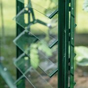 Side view of the green Halls ICON standard louvre kit showing the opening mechanism and glass louvre blades within the greenhouse frame.