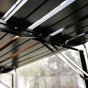 Underside view of the Halls modular folding greenhouse staging HR01906, showing the hinged support arms and folding mechanism fitted inside an ICON 6 6x6 greenhouse.