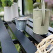 Close-up of the Halls modular folding staging HR01911, showing the black slatted shelf surface inside an ICON 8 8x10 greenhouse.
