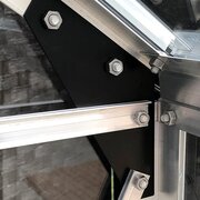 Close-up of the Halls Popular 8x6 aluminium greenhouse frame showing reinforced corner bracing and toughened glass glazing system.