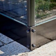 Close-up of corner fixing on Halls Qube 66 6x6 greenhouse base, showing black steel supports and secure bolt connections.