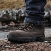 Hoggs of Fife Glencoe Waterproof Leather Trek Boots Size 7 worn by a person outdoors on rocky terrain, demonstrating rugged grip and waterproof protection.