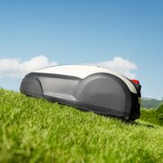 Side profile of the Honda HRM 1000 Miimo robotic lawnmower operating on a sloped grass lawn