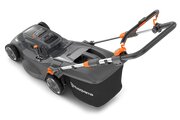 Husqvarna Aspire LC34 Battery Lawnmower (Unit Only) cutting grass with somebody pushing it behind