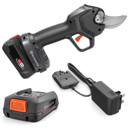 Product shot of the Husqvarna Aspire PS30X-P4A cordless battery secateurs kit with battery and charger