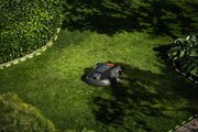 Husqvarna 308V Automower working in a garden