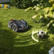 Husqvarna Automower 405XE NERA robotic lawnmower detecting obstacle on garden lawn with object avoidance sensors