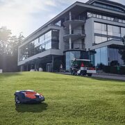 Husqvarna Automower 520 EPOS commercial robotic mower maintaining large corporate lawn outside office building