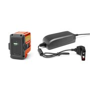 Husqvarna QC80 battery charger with BLi20 36V lithium-ion battery for cordless lawnmowers and garden tools on white background