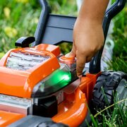Close-up of the realistic controls and glowing lights on the Husqvarna Toy Lawnmower