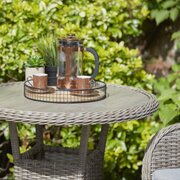 Round table from the Leisure Grow St Tropez Sand 2 seat garden dining set, featuring a woven rattan-effect base and smooth tabletop with coffee set.
