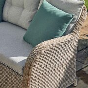 Close-up of the woven sand-toned rattan armrest and cushioned seating from the LG St Tropez Compact Modular Dining Set, showing twisted weave detail and fabric texture.