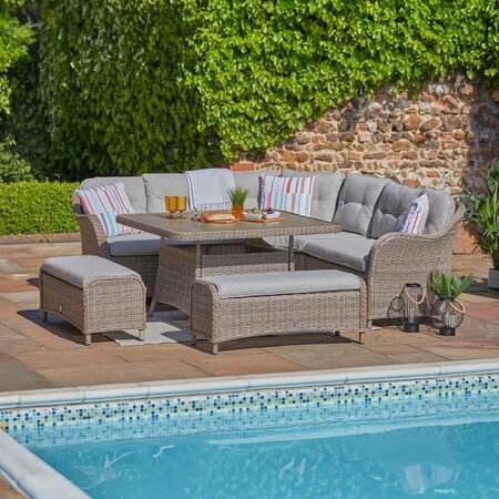 LG St Tropez Sand large square modular sofa set with casual dining table arranged outdoors beside a swimming pool