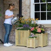 Zest Wooden planters with woman watering plants in the planters