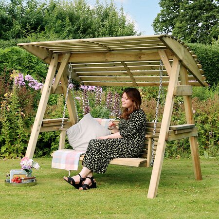 Lady sat on the Zest Miami 2 seater swing enjoying the sun