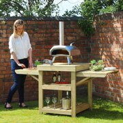 Woman setting up the Garden Pizza Oven Table