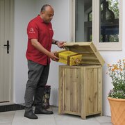 Courier placing a parcel into the Zest Secure Wooden Keep Safe Parcel Store outdoor parcel delivery box with hinged lid